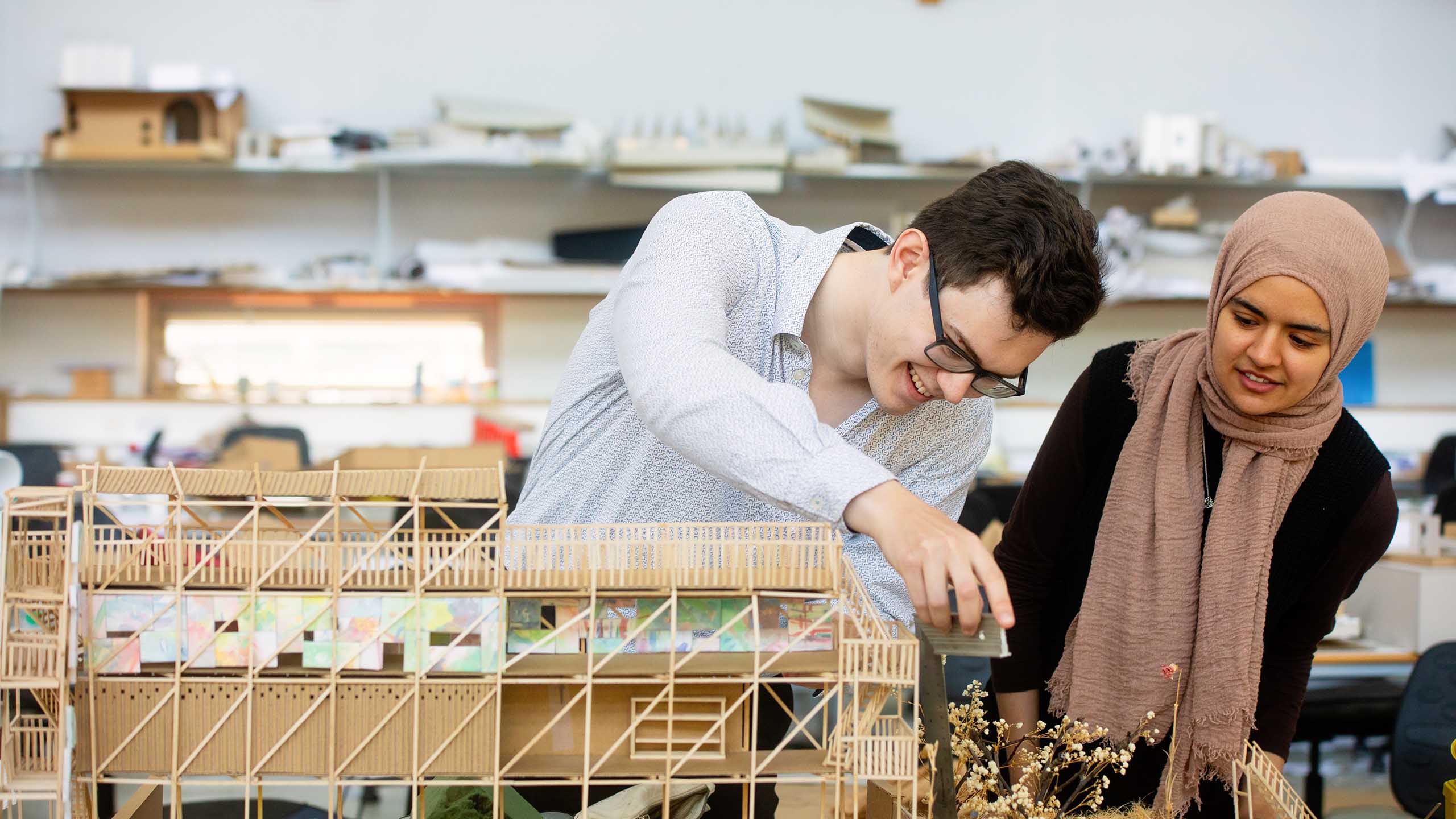 Two students working together on an architecture project
