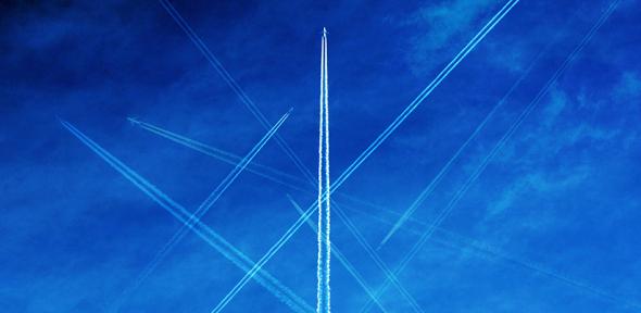 Contrails against a blue sky, Credit: Richard Newstead via Getty Images Contrails against a blue sky