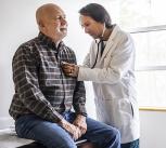 Doctor listening to a man's heart with a stethoscope