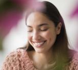 Smiling woman with eyes closed