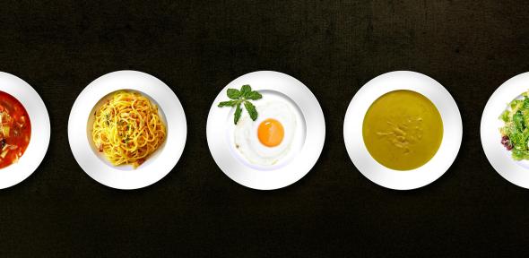 Five plates of food in a row