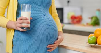 Pregnant woman with a probiotic drink