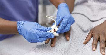 Nurse using pulse oximeter on hospitalised patient